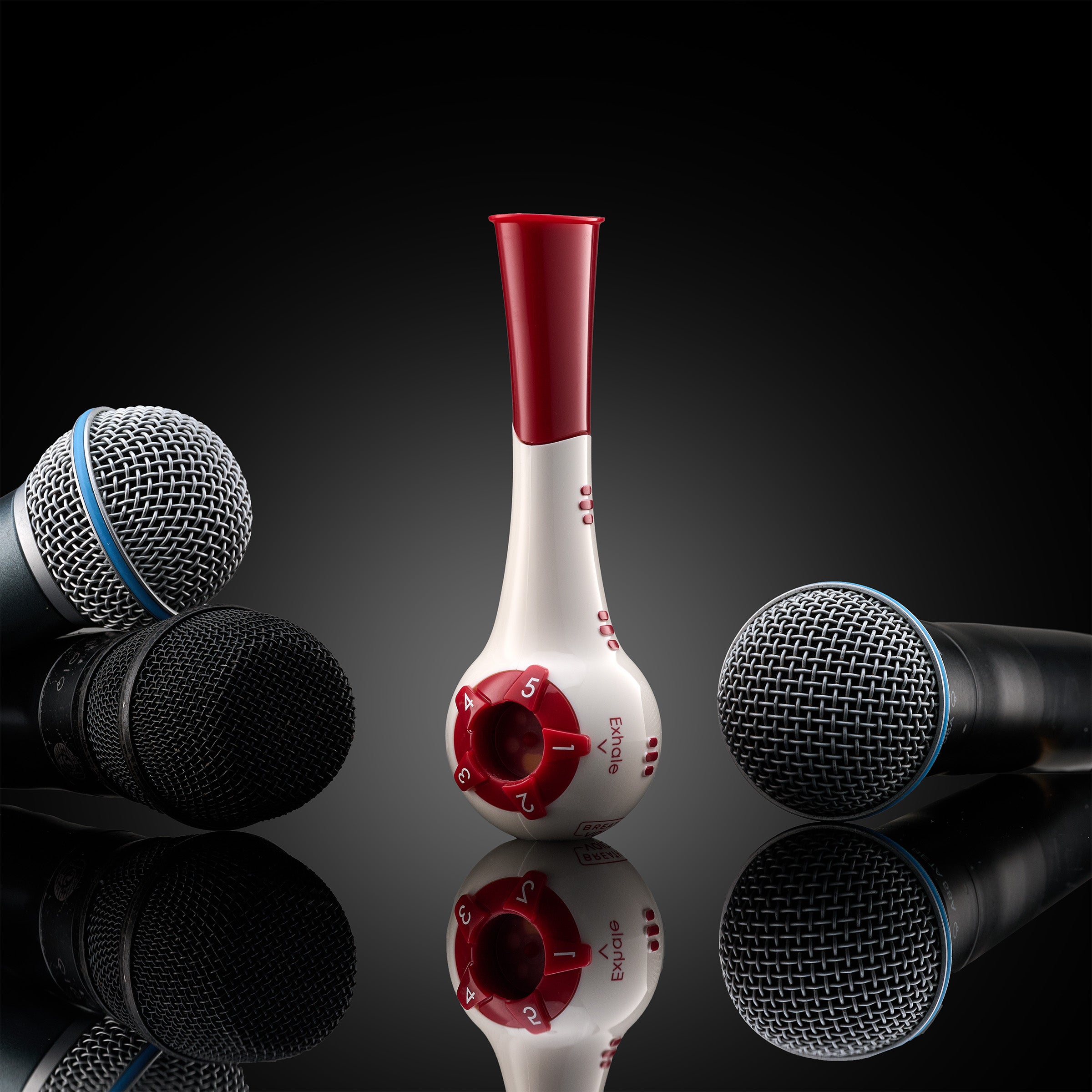Breather Voice — respiratory trainer with props on dark reflective glass.