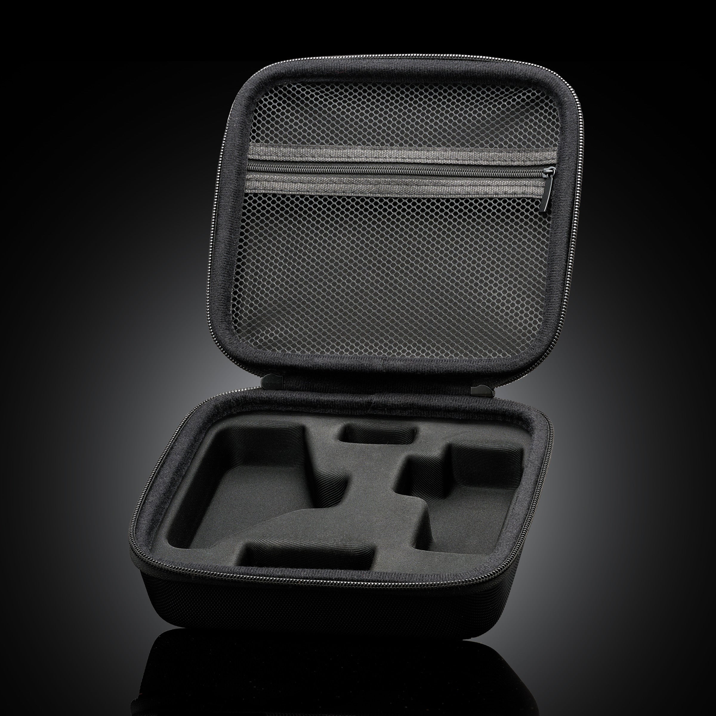 VocalMist Carrying Case — open case interior with mesh pocket and foam insert on dark reflective glass.
