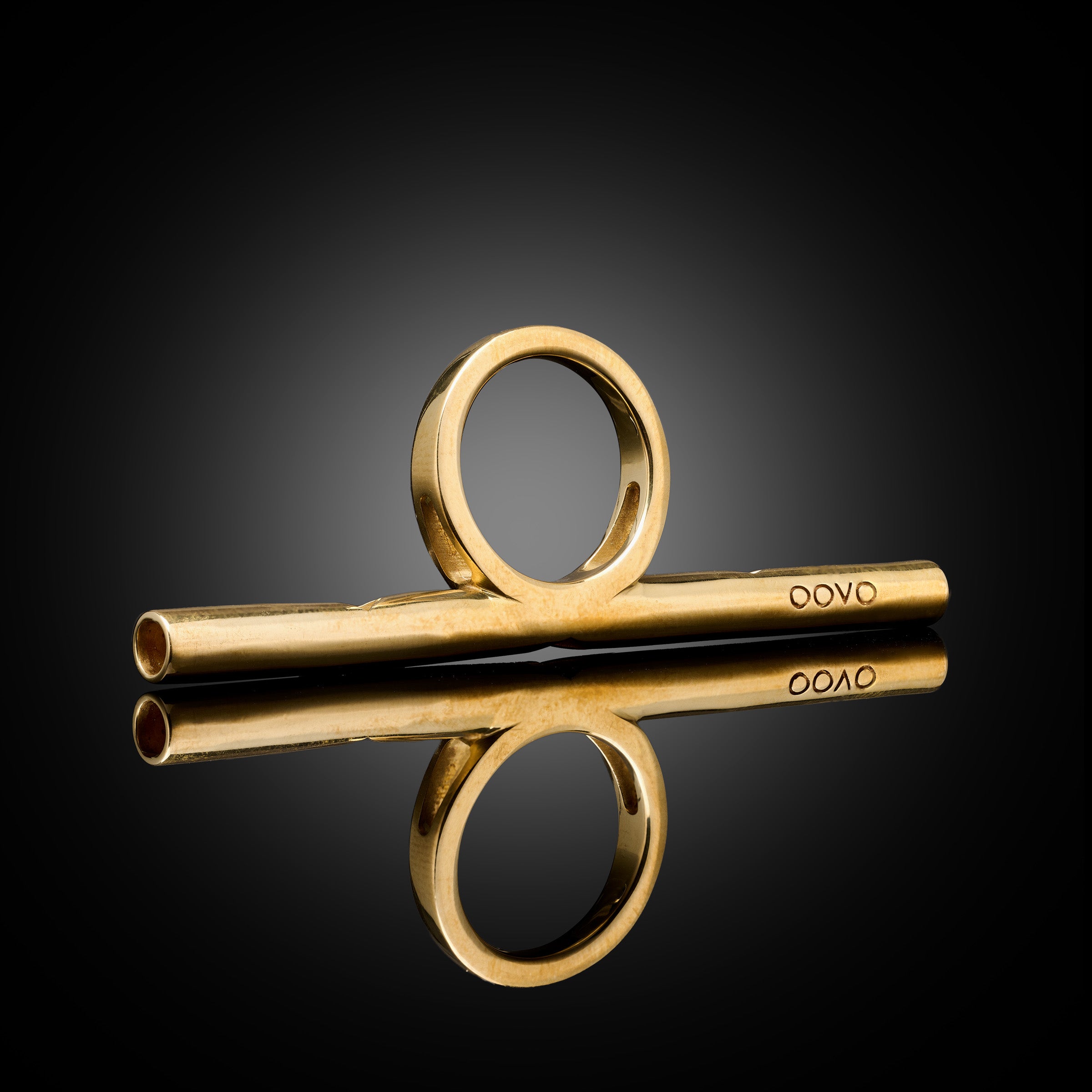 OOVO Sing Ring — gold vocal straw on dark reflective glass.