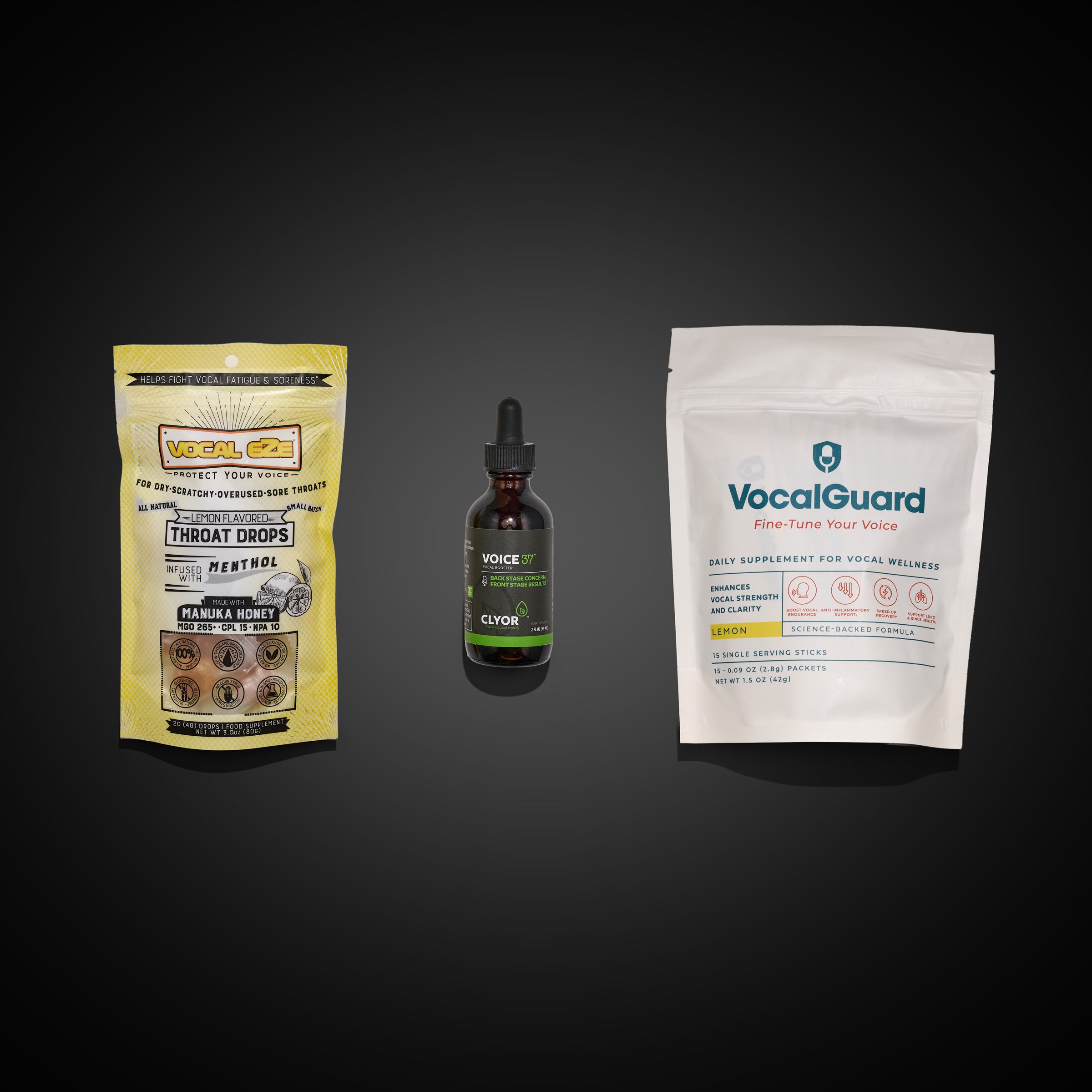 Soothe & Sustain Starter Kit — flat-lay of kit contents on dark ground: Vocal Eze throat drops, Voice 37 tonic, and VocalGuard powder pouch.