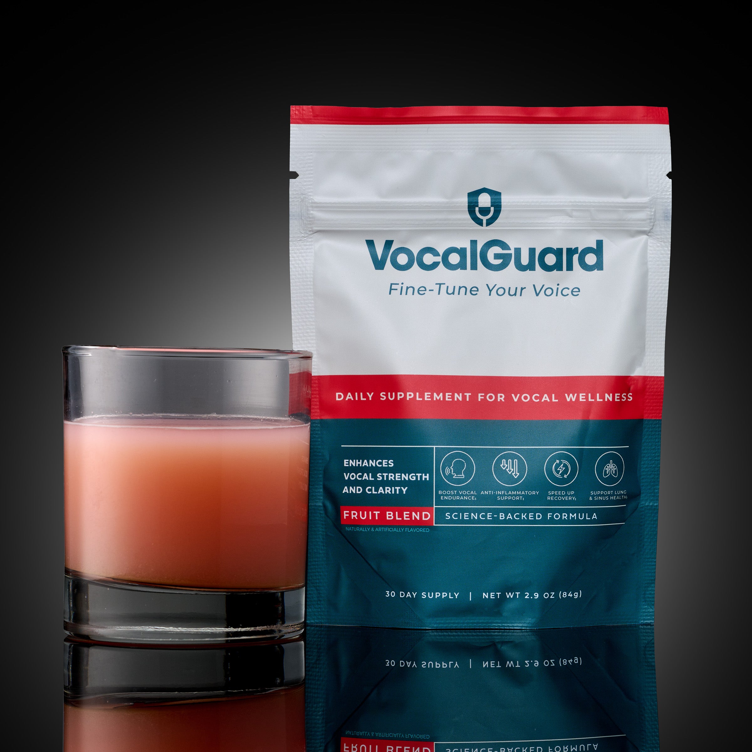 VocalGuard Fruit Blend powder pouch (30-day supply) with mixed glass, studio shot