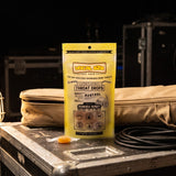 Vocal Eze Lemon Drops pouch propped against a canvas gig bag backstage.