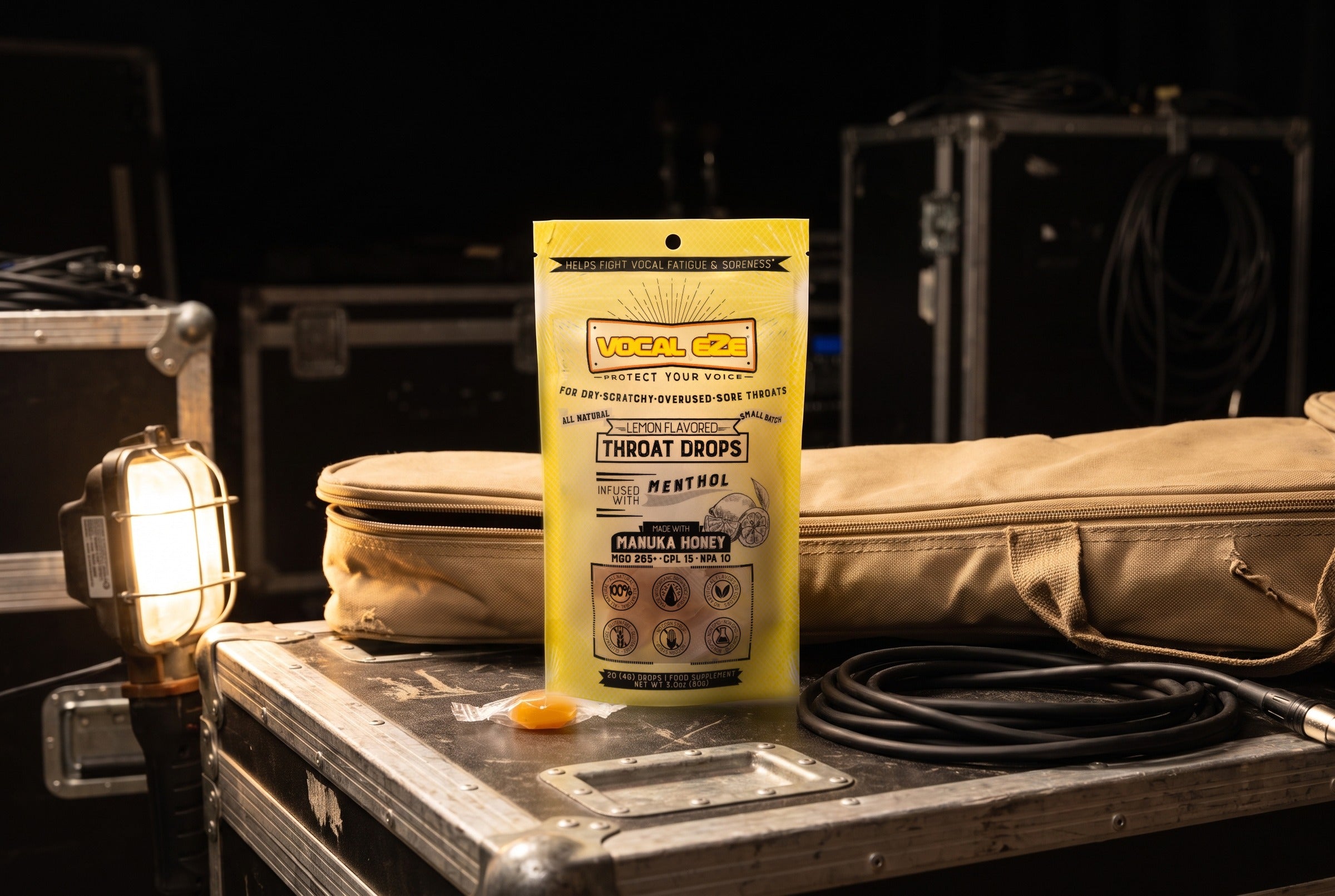 Vocal Eze Lemon Drops pouch propped against a canvas gig bag backstage.