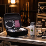 VocalMist carrying case open on a road case backstage with the portable nebulizer standing beside it.
