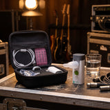 VocalMist carrying case open on a road case backstage with the portable nebulizer standing beside it.