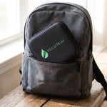 VocalMist carrying case tucked into a backpack pocket in soft daylight.