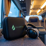 VocalMist carrying case on a tour-bus seat beside headphones.