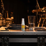Vocal Eze Throat Spray standing on a road case backstage with a coiled cable.