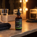 Clyor's Clear Voice 37 Tonic on a theater dressing-room counter under warm mirror lights.