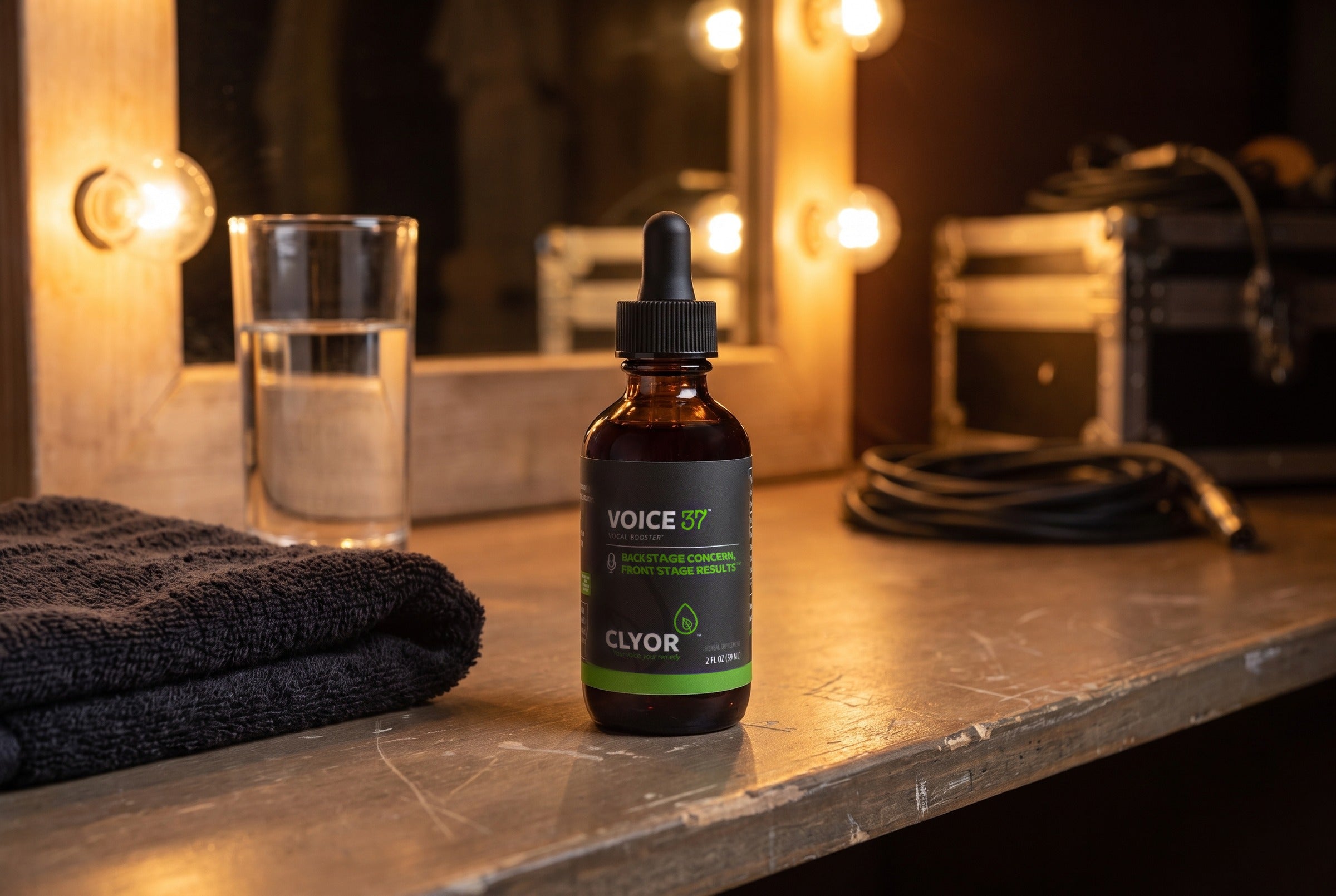 Clyor's Clear Voice 37 Tonic on a theater dressing-room counter under warm mirror lights.