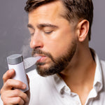 VocalMist Hydration Formula — a singer inhaling mist from the VocalMist nebulizer.