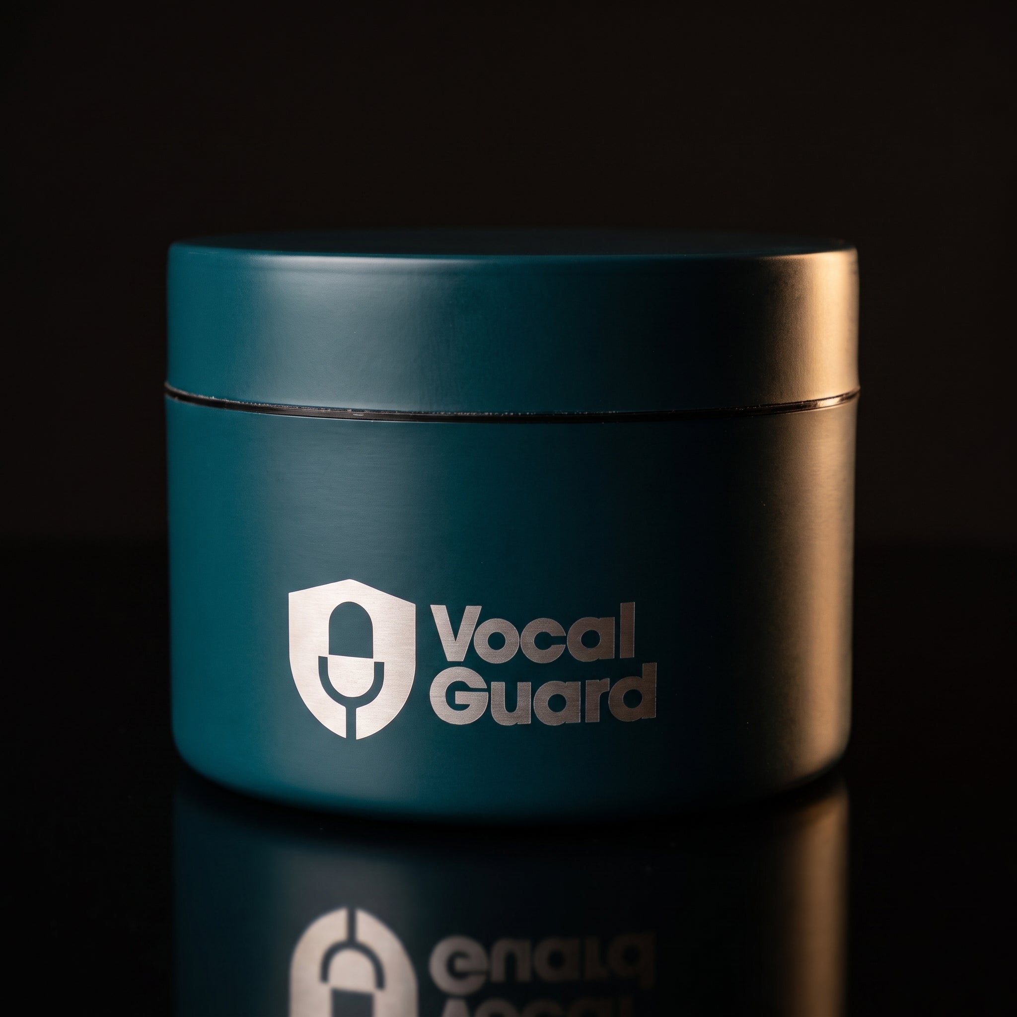 VocalGuard Vault — teal storage tin on black reflective glass, catalog hero.