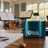 Teal VocalGuard Vault storage tub on a bright rehearsal-room table.