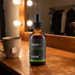 Clyor's Voice 37 vocal booster on a theater dressing-room counter under mirror lights.