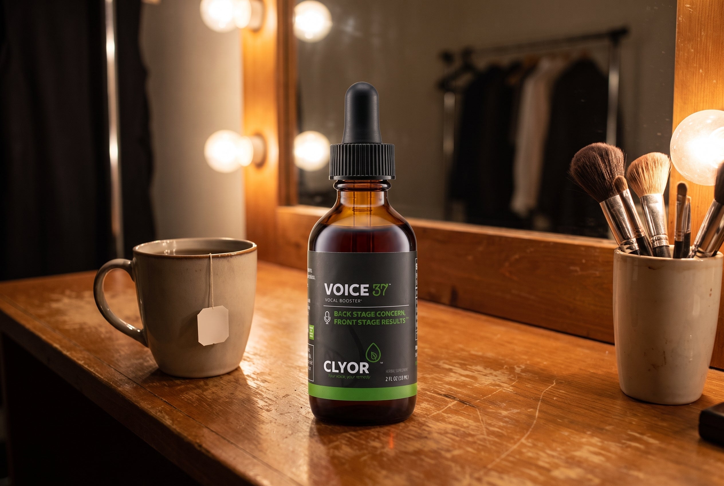 Clyor's Voice 37 vocal booster on a theater dressing-room counter under mirror lights.